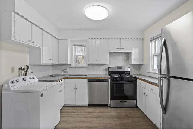 a kitchen with a sink cabinets and stainless steel appliances