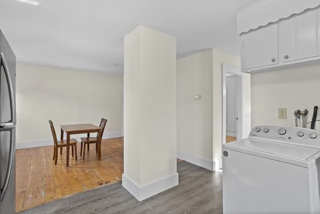 a dining room with furniture and wooden floor