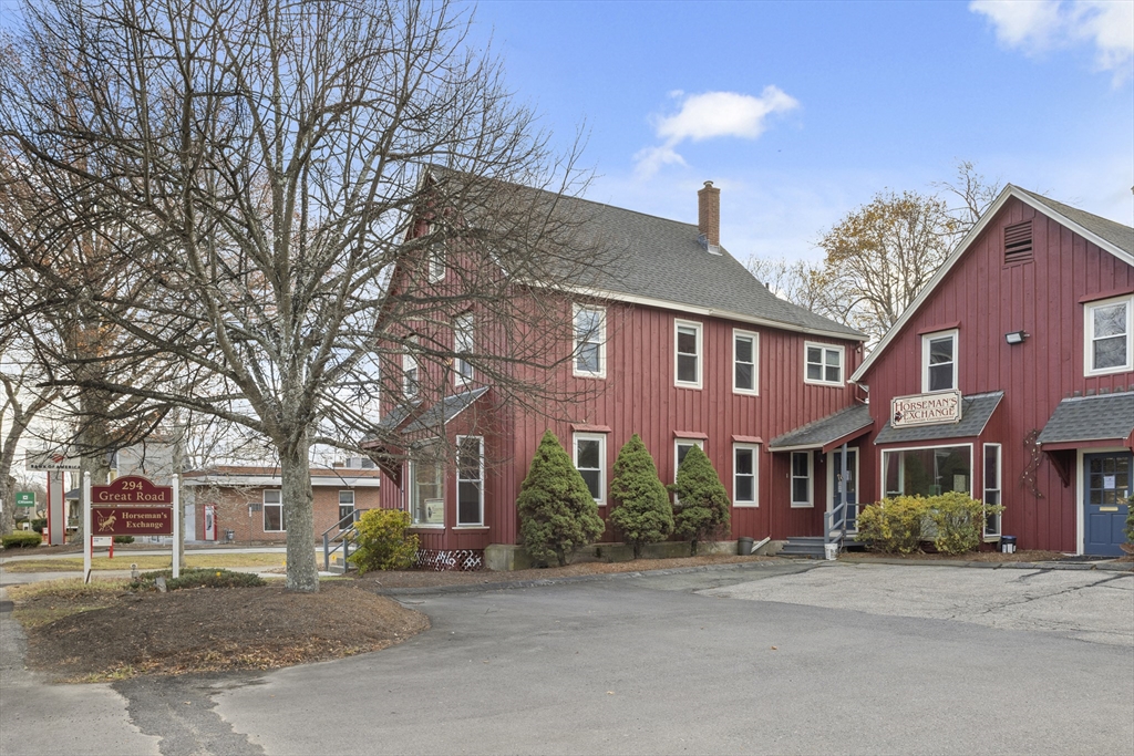 294 Great Road, Unit 2 Littleton, MA 01460 - Photo 2 of 18 a front view of a house with a yard
