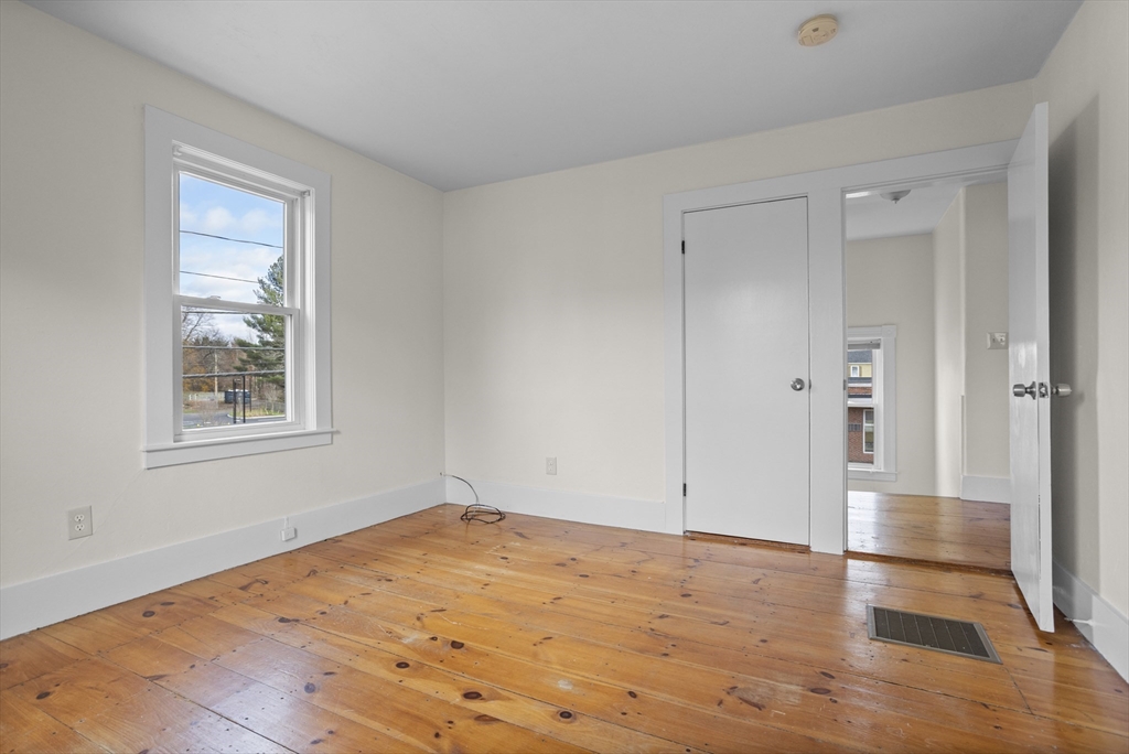 294 Great Road, Unit 2 Littleton, MA 01460 - Photo 6 of 18 a view of empty room with wooden floor and fan