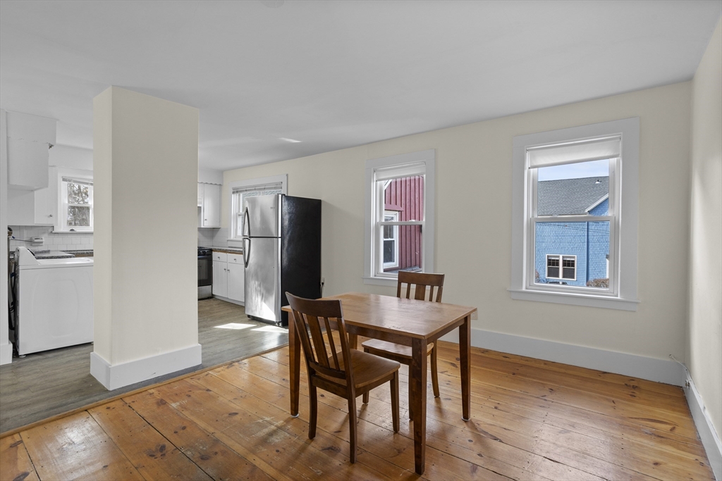 294 Great Road, Unit 2 Littleton, MA 01460 - Photo 9 of 18 a kitchen with stainless steel appliances refrigerator dining table and chairs