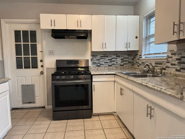 a kitchen with cabinets and appliances