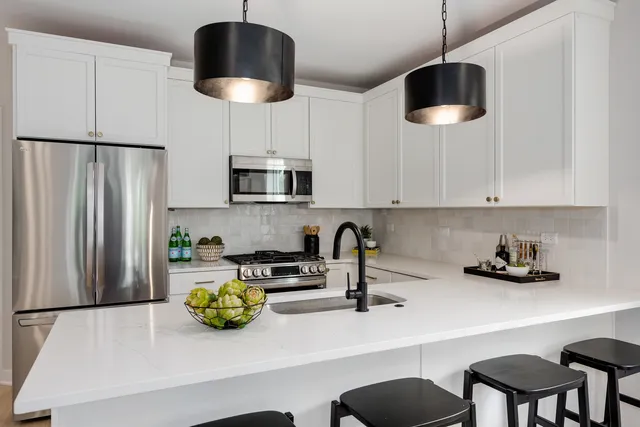 a kitchen with stainless steel appliances a microwave a stove and refrigerator