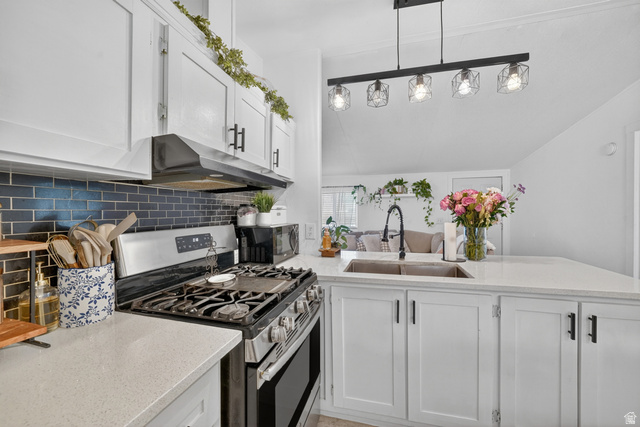 160 Cushing Way Layton, UT 84041 - Photo 12 of 23 Modern kitchen featuring white shaker cabinetry, stainless steel appliances, dark subway tile backsplash, and light-tone countertops
