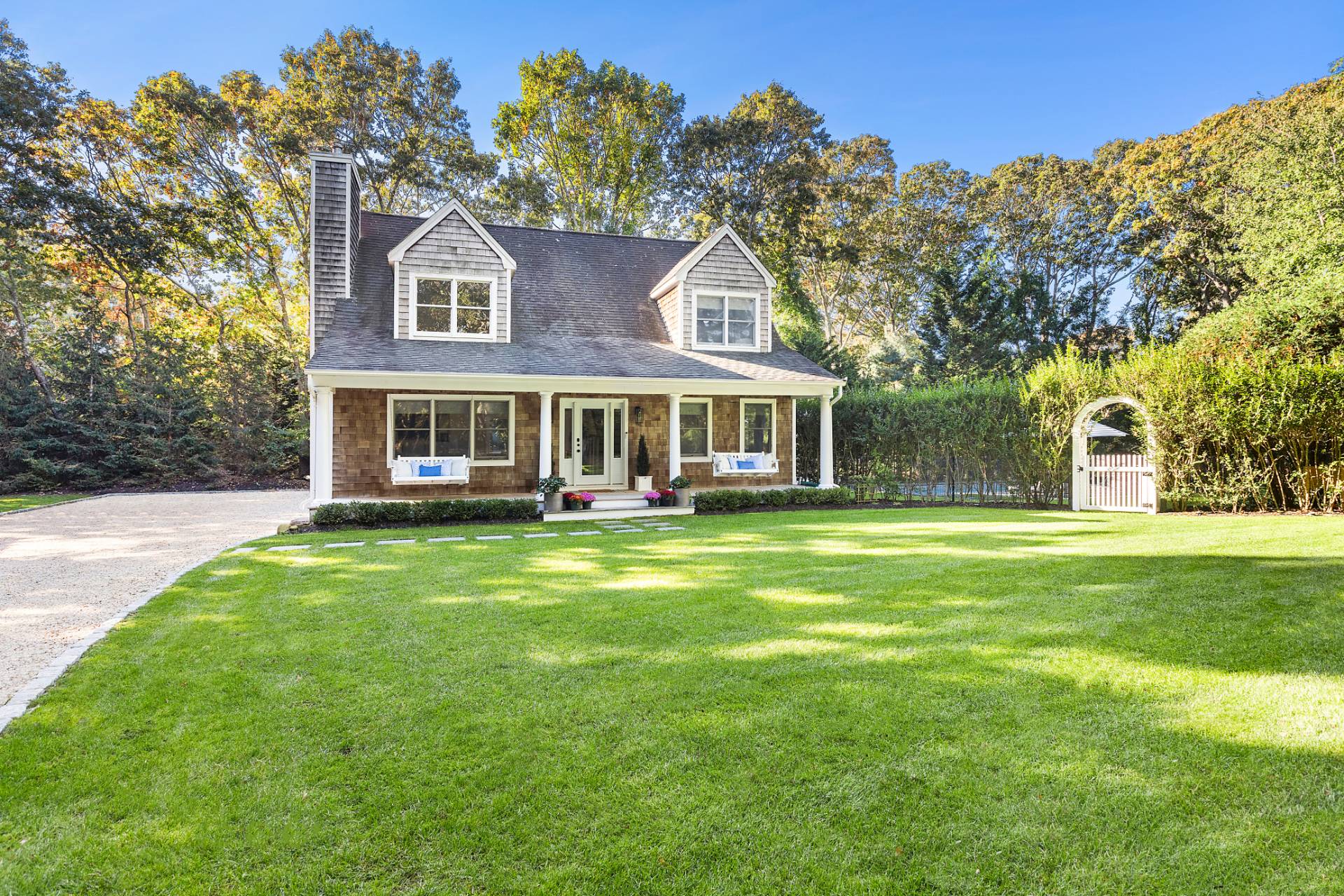 32 Old Fish Cove Road Southampton, NY 11968 - Photo 2 of 23 a front view of a house with a garden