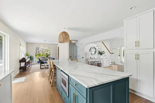a kitchen with stainless steel appliances granite countertop a kitchen island a stove a cabinets a sink and a refrigerator