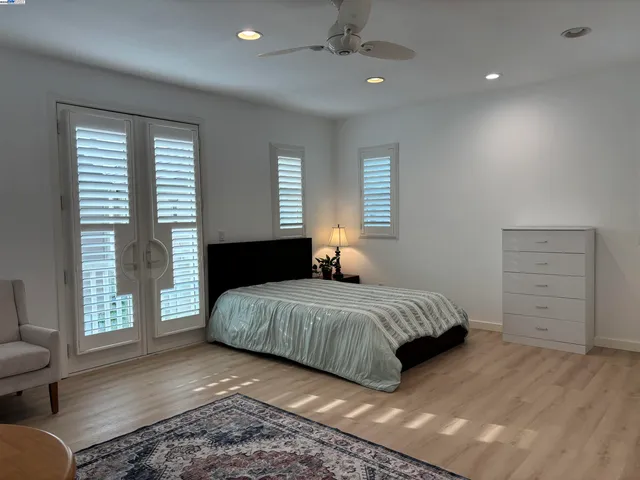 a view of a house with brick walls and a yard with plants