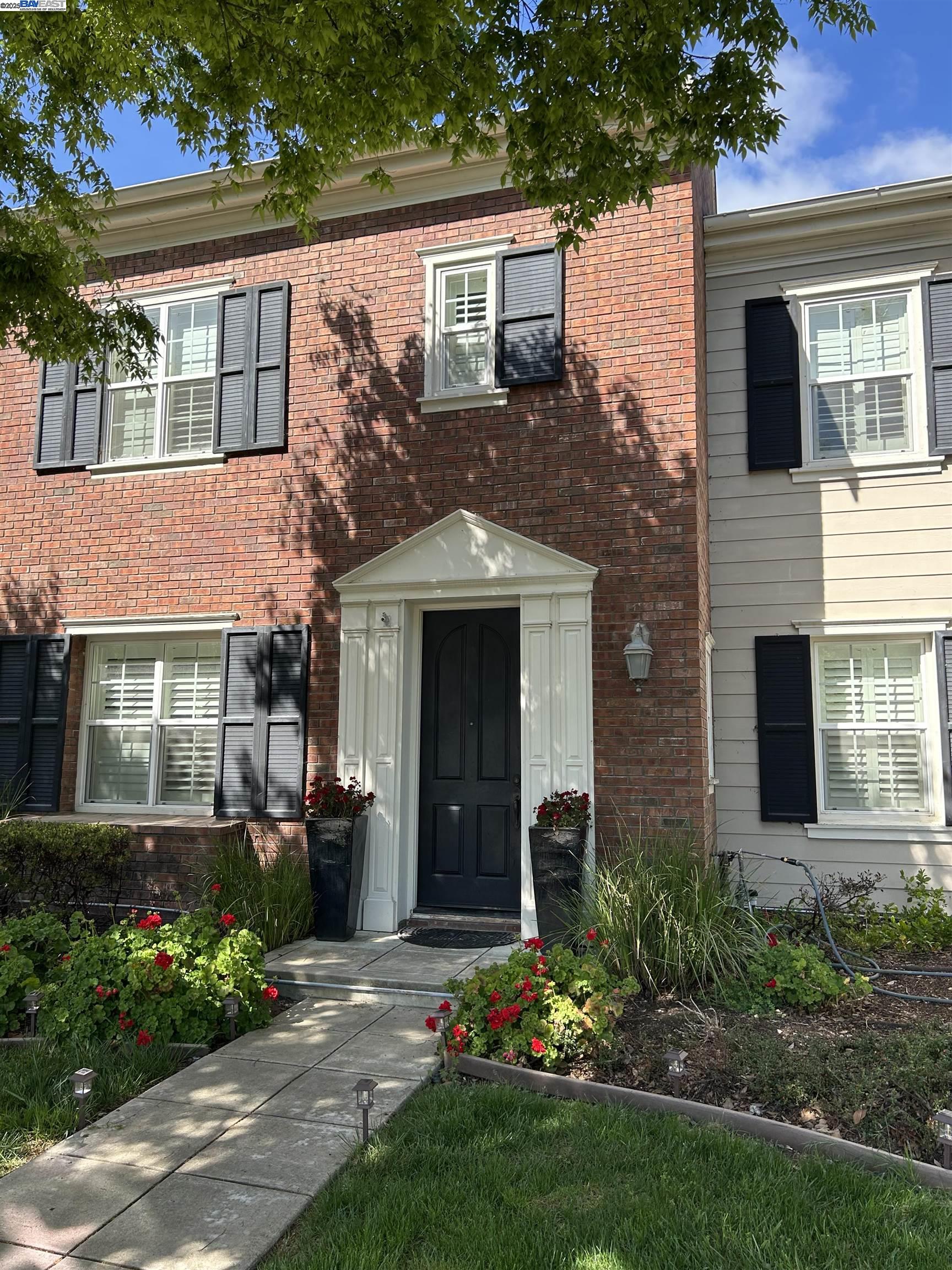 3089 Sweetviolet Drive, Unit B San Ramon, CA 94582 - Photo 12 of 13 a view of a house with brick walls and a yard with plants