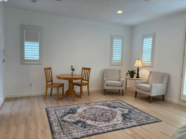a living room with furniture and a rug