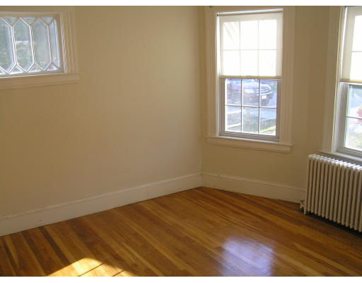 26-28 Harding Road Norwood, MA 02062 - Photo 2 of 6 an empty room with wooden floor and windows