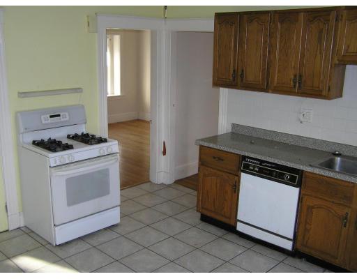 26-28 Harding Road Norwood, MA 02062 - Photo 3 of 6 a kitchen with stainless steel appliances granite countertop a stove and a microwave