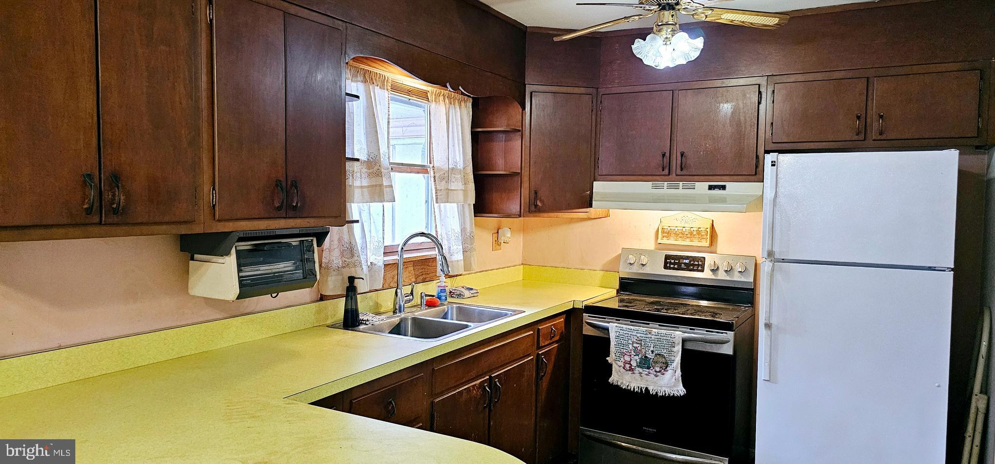 10 Beavens Road Reading, PA 19608 - Photo 6 of 28 a kitchen with stainless steel appliances a stove refrigerator sink and cabinets