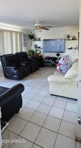 a living room with furniture and kitchen view
