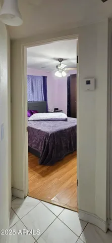 a bedroom with a bed and a mirror