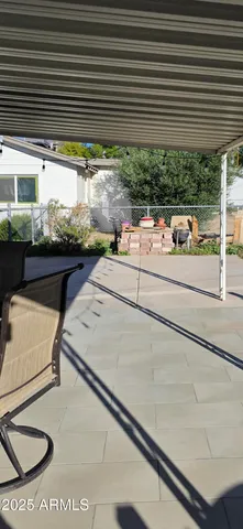 a view of a house with a wooden fence
