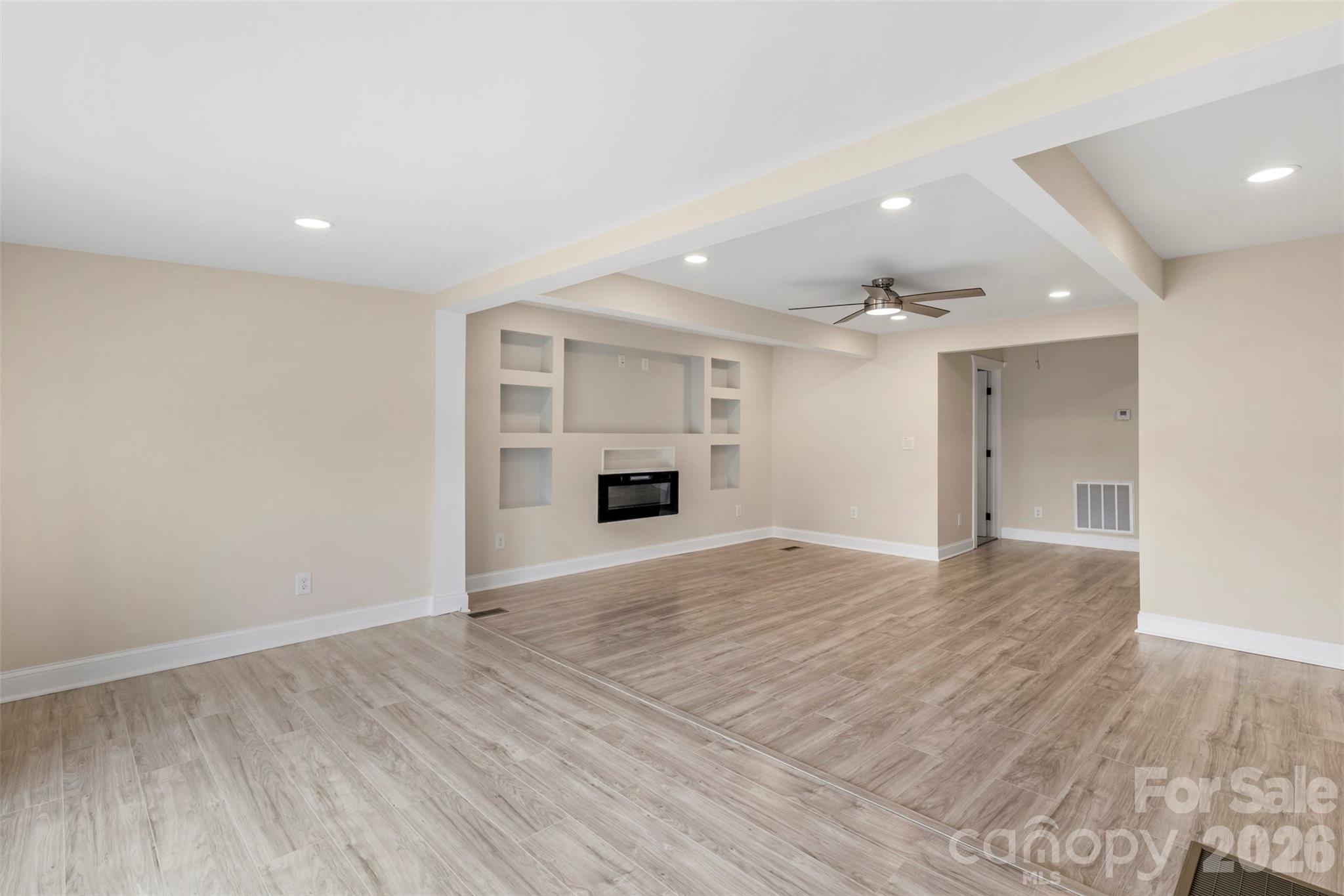 2480 Artz Road Salisbury, NC 28146 - Photo 10 of 33 a view of empty room with wooden floor and fireplace