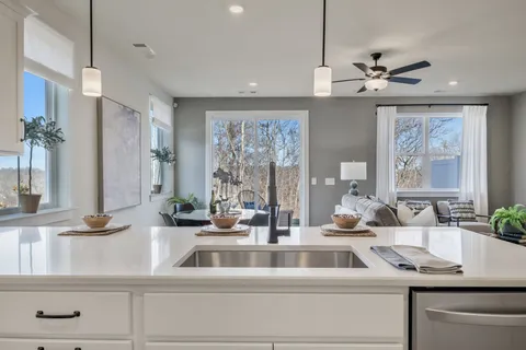 a kitchen with a sink and a large mirror