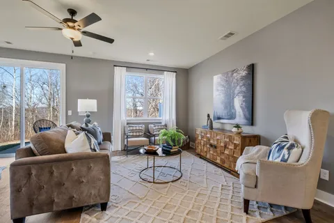 a living room with furniture and a large window