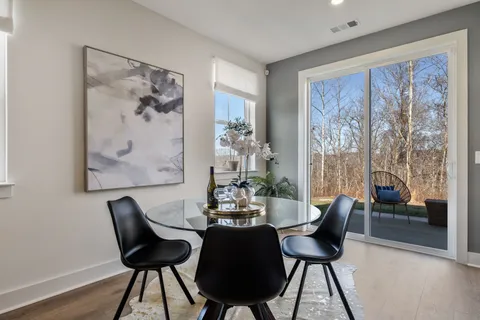 a view of a dining room with furniture wooden floor and a large window