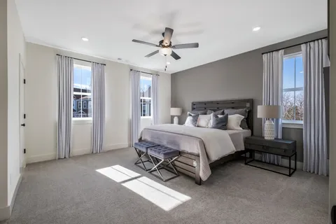 a bedroom with a bed couch and window