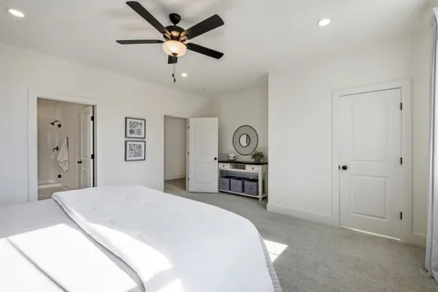 a spacious bedroom with a bed and a table