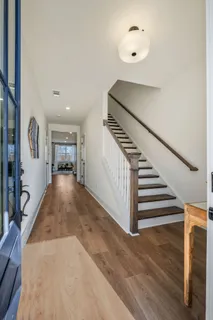 a view of entryway and hall with wooden floor