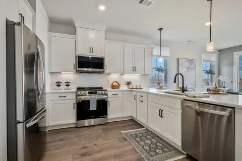 a kitchen with a sink stove and refrigerator