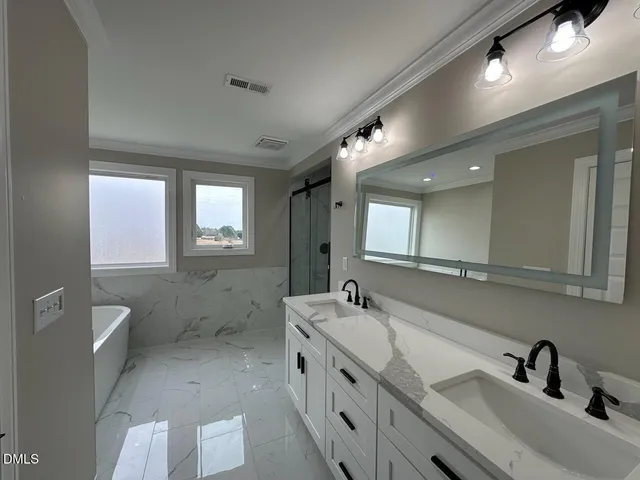 a bathroom with a double vanity sink a toilet and a mirror