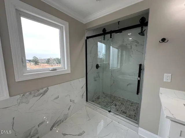 a bathroom with a glass shower door