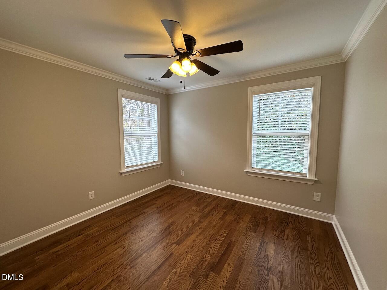 913 Clayton Road Benson, NC 27504 - Photo 23 of 35 a view of an empty room with wooden floor and a window