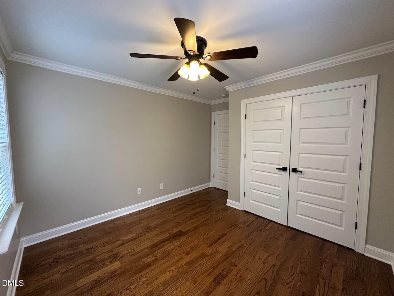913 Clayton Road Benson, NC 27504 - Photo 24 of 35 an empty room with wooden floor a ceiling fan and windows
