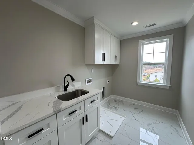 a kitchen with a sink cabinets and window