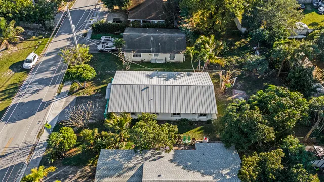 an aerial view of a house with a swimming pool yard and outdoor seating
