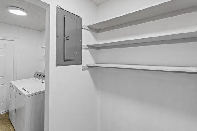 a view of an empty room with wooden floor