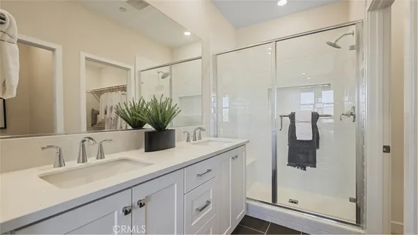 a bathroom with a shower sink and vanity