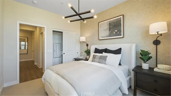 a bedroom with a bed and a lamp on table