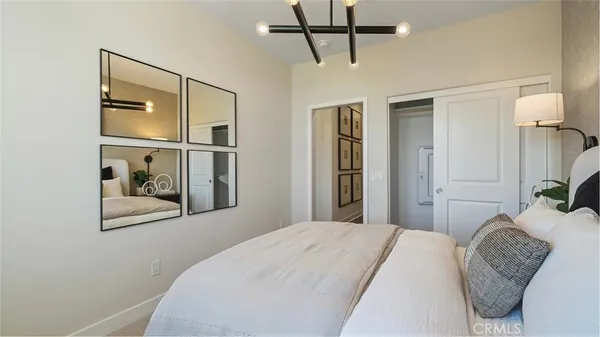 a bedroom with a bed and a mirror