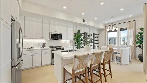 a kitchen with appliances a sink and cabinets