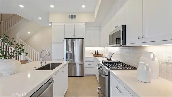 a kitchen with a sink a stove and refrigerator