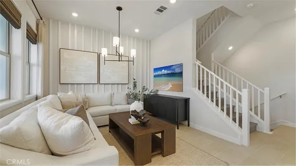 a living room with furniture and a chandelier