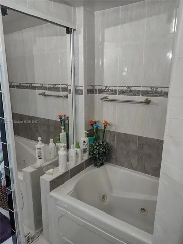 a bathroom with double sink and a mirror