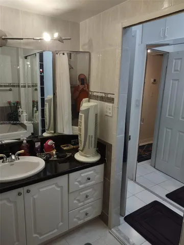 a bathroom with a sink toilet and mirror