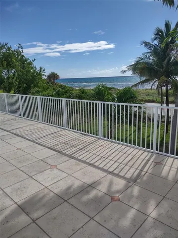 a view of balcony with wooden floor and fence