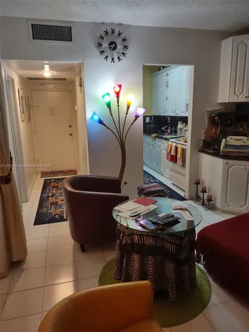 a living room with furniture and flowers