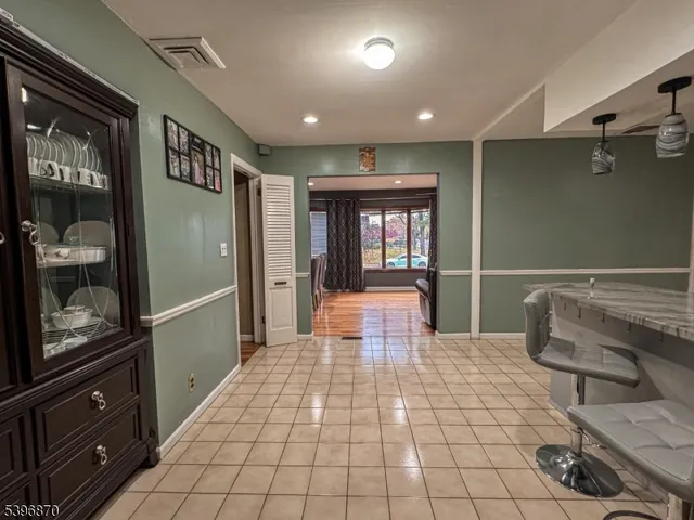 a living room with furniture a dining table and a flat screen tv