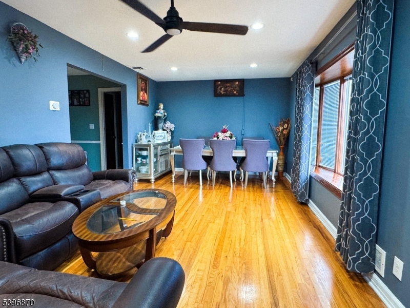 617 Sycamore Street Paramus, NJ 07652 - Photo 4 of 20 a living room with furniture a fireplace and a flat screen tv
