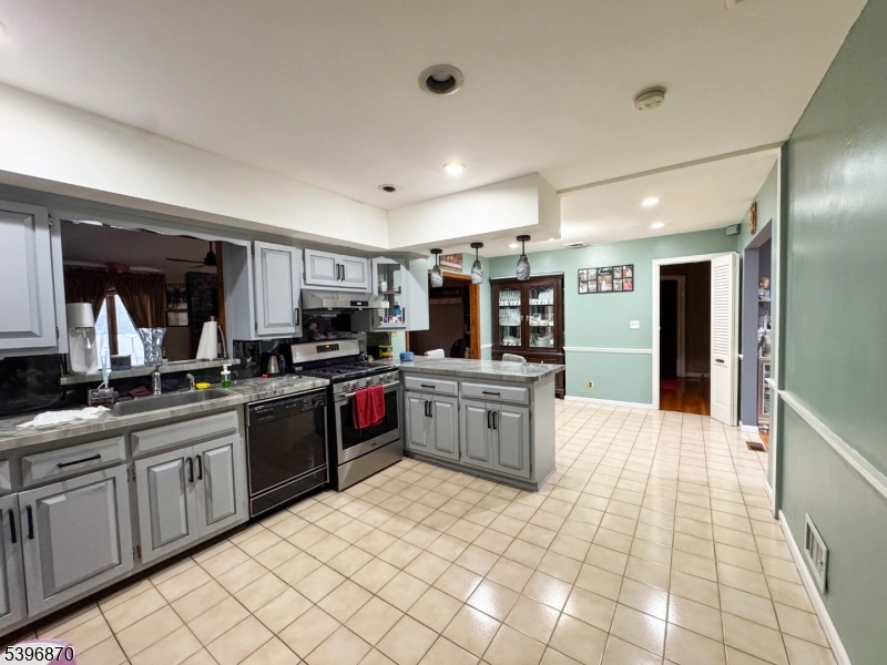617 Sycamore Street Paramus, NJ 07652 - Photo 5 of 20 a kitchen with stainless steel appliances granite countertop a refrigerator and a sink