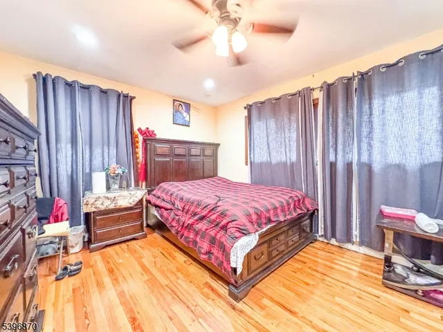 a spacious bedroom with a bed and a chandelier