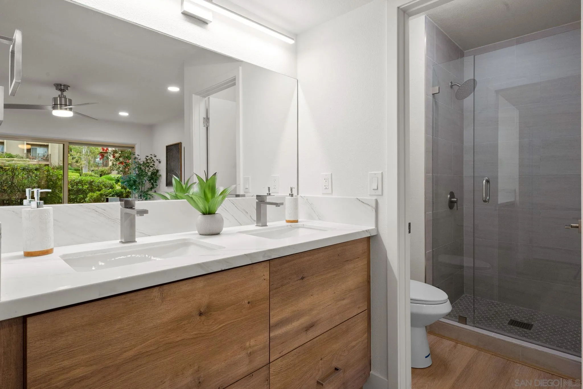 5700 Baltimore Drive La Mesa, CA 91942 - Photo 20 of 37 a bathroom with a granite countertop sink a toilet and shower