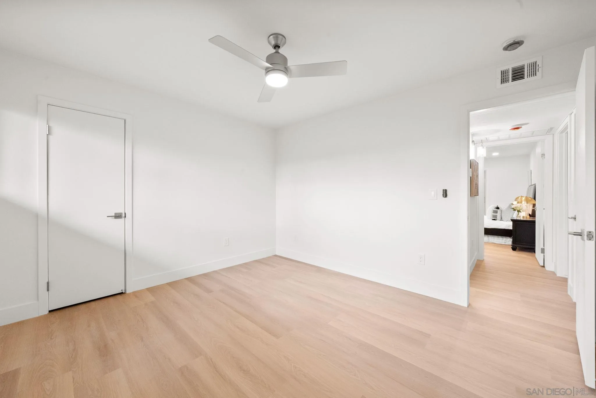 5700 Baltimore Drive La Mesa, CA 91942 - Photo 23 of 37 a view of a livingroom with wooden floor and a ceiling fan